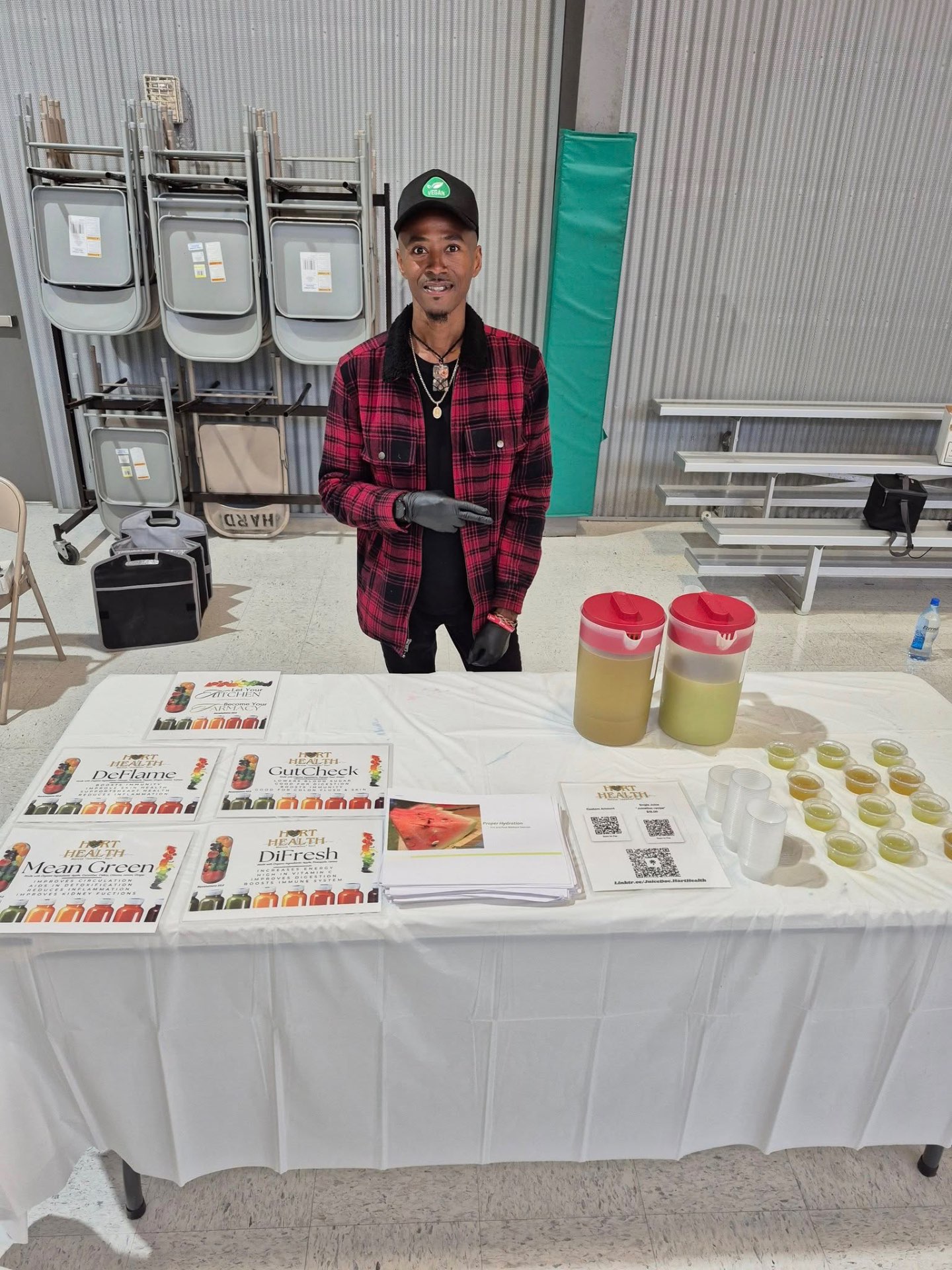 Marcus at his Hart Health juice table serving fresh pressed juice