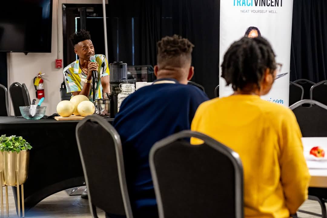 Marcus leading a wellness talk with attendees listening